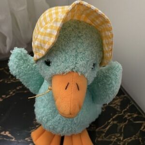 Cute clean stuffed duckling with yellow gingham bonnet, weighted bottom